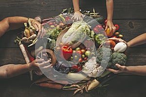 Fresh vegetables and hands on a wooden table. Waste-free vegetable growing and sustainable food