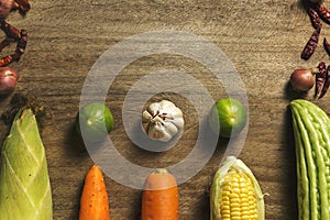 Fresh vegetables and herb appearing on wooden