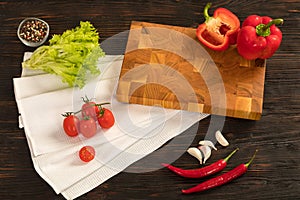 Fresh vegetables, herbs and spices on a cutting board