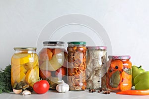 Fresh vegetables and jars of pickled products