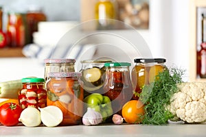 Fresh vegetables and jars of pickled products