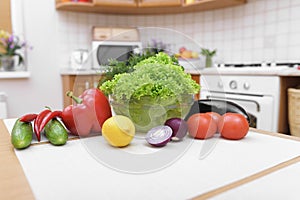 Fresh vegetables on kitchen table.