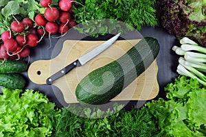 Fresh vegetables and kitchen utensils on wooden background. Top