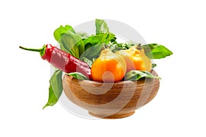 Fresh vegetables with leaves in a earthenware pot isolated on