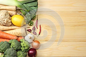 Fresh vegetables on light wooden background. Mockup for menu or recipe. Top view with copy space