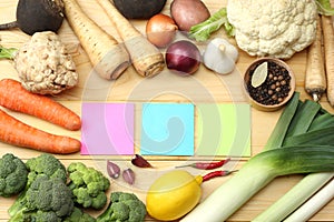 Fresh vegetables on light wooden background. Mockup for menu or recipe. Top view with copy space
