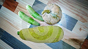 Fresh vegetables pumpkin, Jack fruit and cucumber on wooden texture background