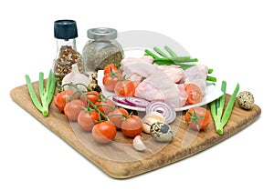 Fresh vegetables, quail eggs and raw chicken wings isolated on w