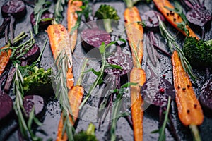 Fresh vegetables for roasting on rustic dark background