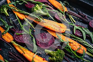 Fresh vegetables for roasting on rustic dark background