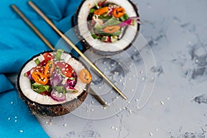 Fresh vegetables salad in coconut peel.