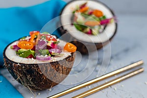 Fresh vegetables salad in coconut peel.