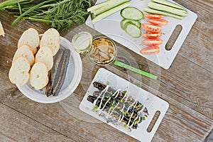 Fresh vegetables with salad and grilled sausages on a wooden table background