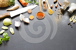 Fresh vegetables spices and food ingredients on blackboard background abstract concept