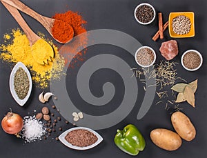 Fresh vegetables, Spices and herbs scattered on dark background. Natural and bio ingredients for cooking Copy space for your text.