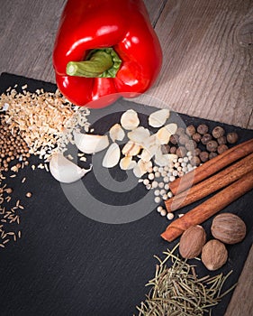 Fresh vegetables, Spices and herbs scattered on dark background. Natural and bio ingredients for cooking Copy space for your text.