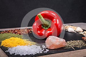 Fresh vegetables, Spices and herbs scattered on dark background. Natural and bio ingredients for cooking Copy space for your text.