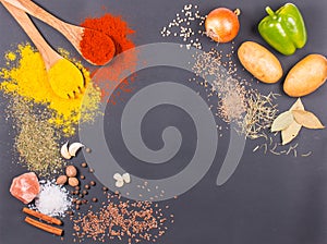 Fresh vegetables, Spices and herbs scattered on dark background. Organic products