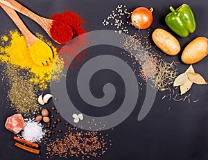 Fresh vegetables, Spices and herbs scattered on dark background. Organic products. Copy space for your text.