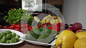 Fresh vegetables still life. Kitchen table with fresh organic fruits and vegetables. Parallax effect shot.