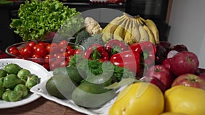 Fresh vegetables still life. Kitchen table with fresh organic fruits and vegetables. Parallax effect shot.
