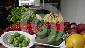 Fresh vegetables still life. Kitchen table with fresh organic fruits and vegetables. Parallax effect shot.