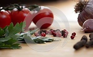 Fresh vegetables on the table. Food background. Close up. Cherry tomatoes, a bunch of parsley, chopped red pepper, garlic and