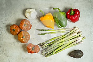 Fresh vegetables on table, tomatoes, garlic, asparagus, avocado