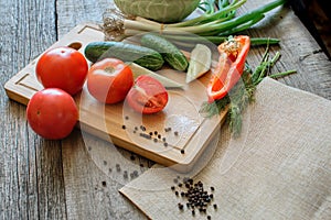 fresh vegetables tomatoes, cucumber, chili peppers, dill on wooden background.