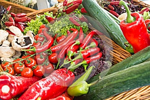 Fresh vegetables: tomatoes, cucumbers, lettuce, peppers, champignons in the basket at the street farm market