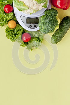 Fresh vegetables on vase on yellow background. Healthy eating, diet planning, weight loss, detox, organic farming concept