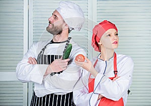 Fresh vegetables. Vegetarian family. Woman and bearded man cooking together. Chefs of organic food restaurant. Cooking