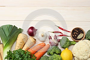 Fresh vegetables on white wooden background. Mockup for menu or recipe. Top view with copy space