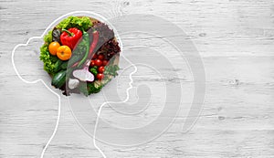 Fresh vegetables in woman head symbolizing health nutrition