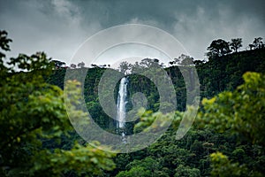 Fresh vegetation at Anton Valley in Panama with a waterfall and cloudscape