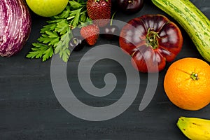 FRESH VEGTABLES AND FRUIT ON BLACK CHALK BACKGROUND