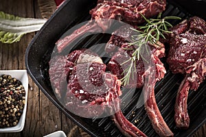 Fresh venison rack on dark wooden background.