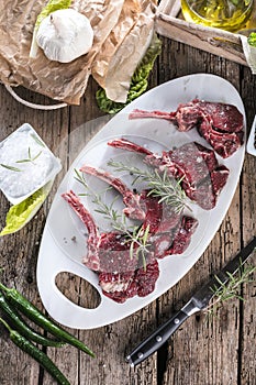 Fresh venison rack on dark wooden background.