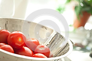 Fresh, Vibrant Roma Tomatoes in Colander with Wate