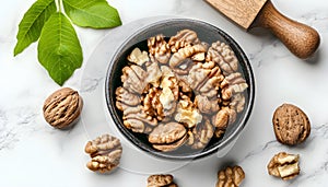 Fresh walnuts in bowl and nutcracker on gray table, flat lay