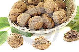 Fresh walnuts with walnut leaves in a basket