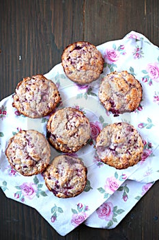 Fresh and warm homemade muffins on tablecloth