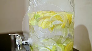 Fresh water with in glass decanter with lemon and lime