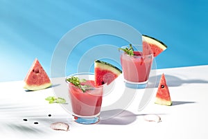 Fresh water melon juice and watermelon slice on blue background. summer drink