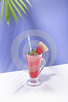 Fresh water melon juice and watermelon slice on color background. summer drink