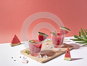 Fresh water melon juice and watermelon slice on red background. summer drink