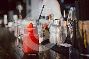 Fresh water melon smoothie in the glass jar on counter bar.