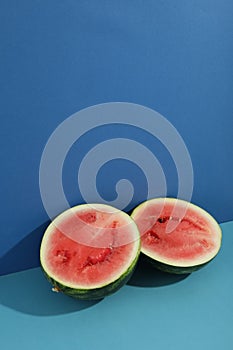 Fresh watermelon halves on two tone background