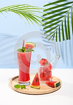 Fresh watermelon juice and watermelon slice on pastel color background. cooling beverage summer drink