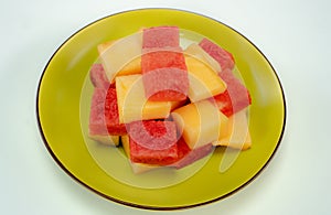 Fresh watermelons and melons on a green plate